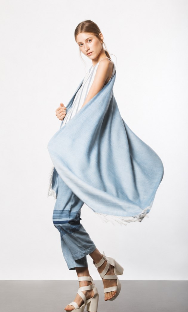 A model wearing a length of indigo-dyed cloth draped over the shoulder